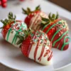 Festive white and dark chocolate-covered strawberries with red, green, and gold sprinkles, perfect for a Christmas chocolate covered strawberries recipe.