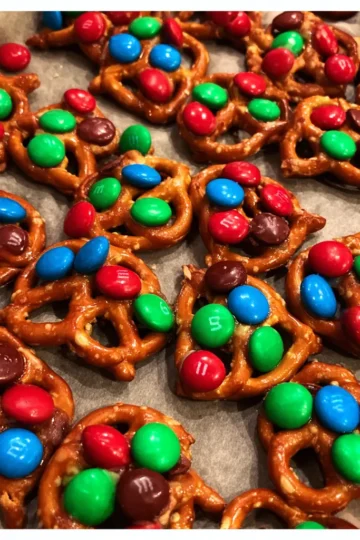 Close-up of colorful M&M-adorned pretzels, a perfect Christmas pretzel recipe treat.