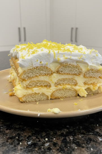 A beautifully layered Limoncello Tiramisu dessert with creamy mascarpone, ladyfingers, and fresh lemon zest garnish.